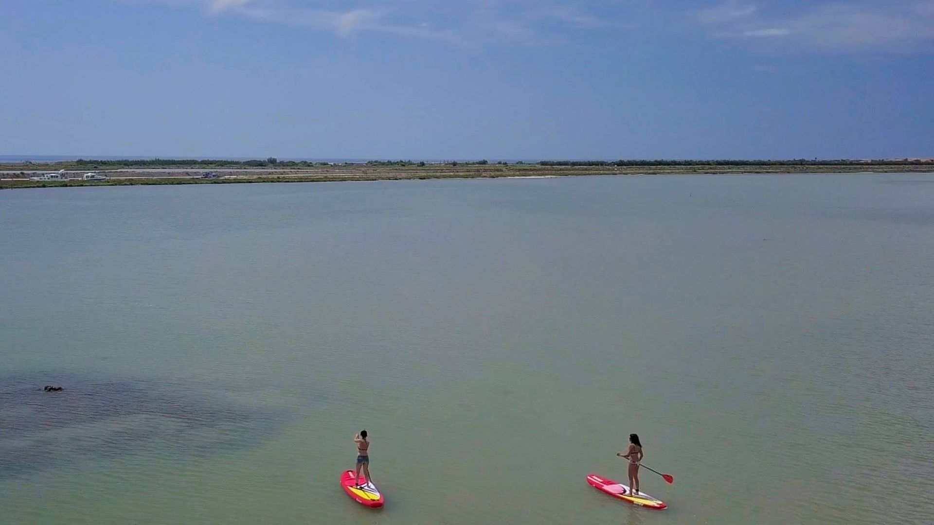 2 jeunes femmes font du paddle sur l'étang de Thau