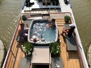 Vue sur l'extérieur de la Péniche Espérance et son jacuzzi, à Capestang