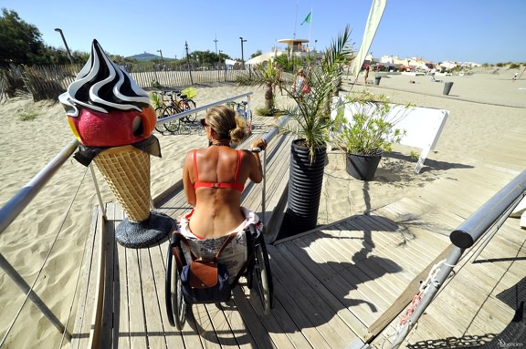 Jeune fille en fauteuil dans un restaurant de plage