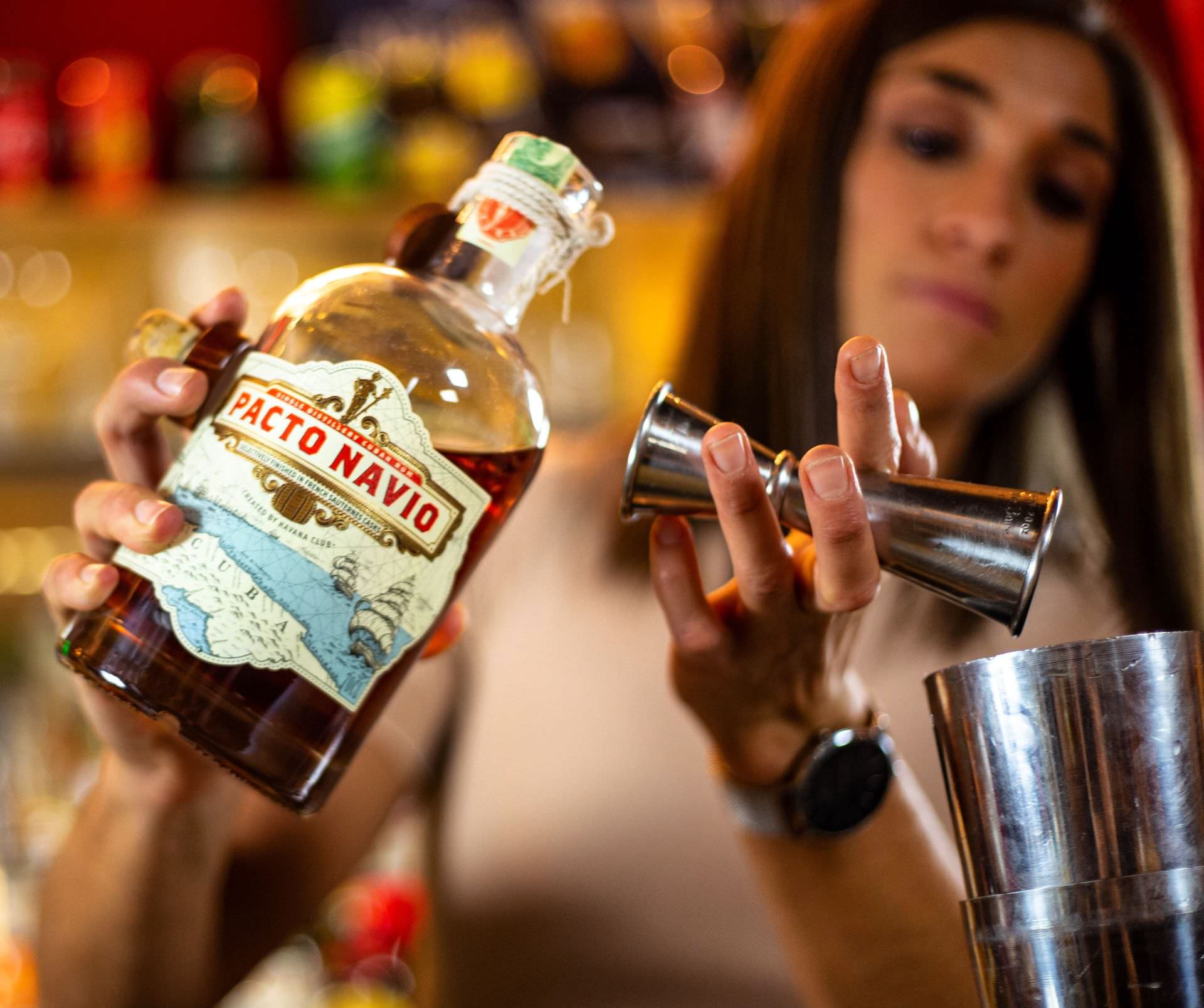 Femme en train de faire un cocktail dans un shaker avec du Rhum à La Part des Anges