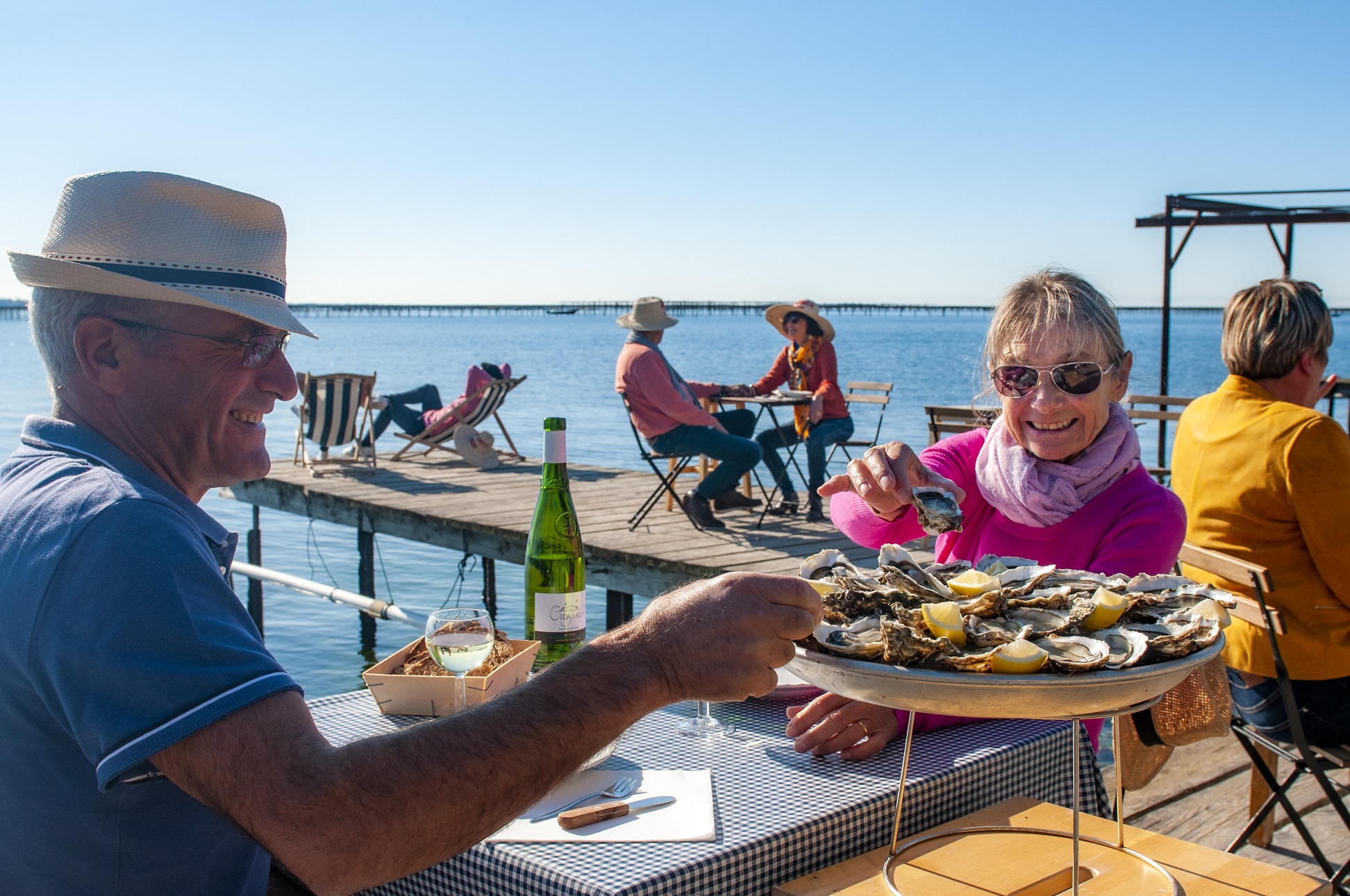 Déjeuner d'un couple autour d'un plateau de fruits de mer dans un mas conchylicole à Loupian