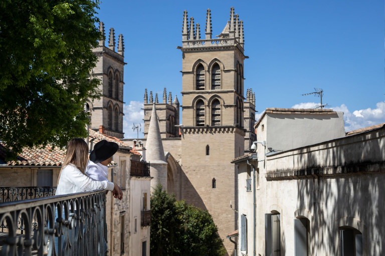Jeune couple qui admire la cathédrale Saint Pierre depuis un belvédère au bout de la place de la Canourgue à Montpellier