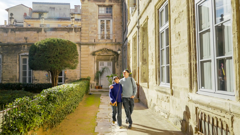 Un couple se promène dans la cour d'un hôtel particulier de Montpellier