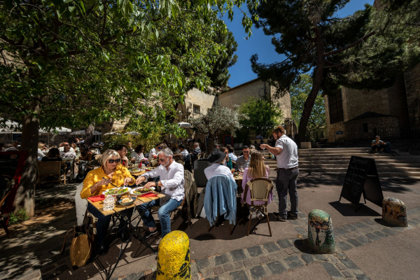 Personnes attablées en terrasse dans le quartier Saint-Roch de la ville de Montpellier par un temps de beau soleil